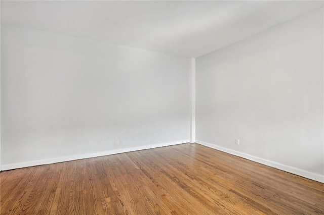 unfurnished room featuring hardwood / wood-style flooring