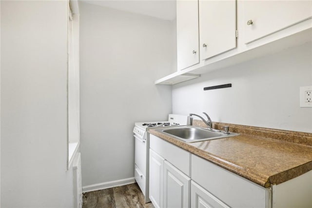 kitchen with dark hardwood / wood-style flooring, white range, white cabinetry, and sink