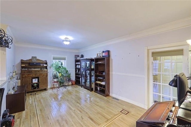 office featuring light wood-type flooring and ornamental molding