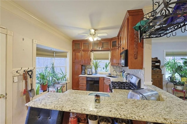 kitchen with backsplash, kitchen peninsula, a wealth of natural light, and black appliances