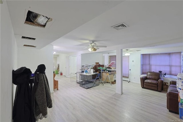 living room featuring ceiling fan and light hardwood / wood-style flooring