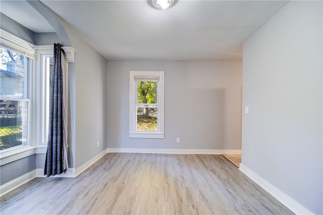 empty room with light hardwood / wood-style flooring