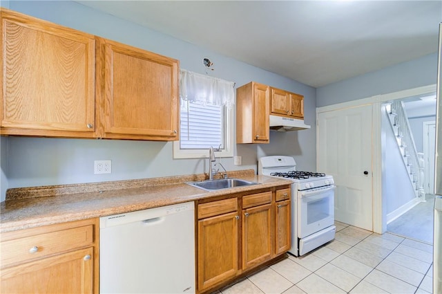 kitchen featuring sink, light tile patterned floors, and white appliances