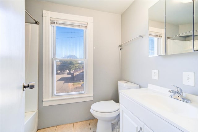 full bathroom featuring tile patterned flooring, vanity, toilet, and plenty of natural light