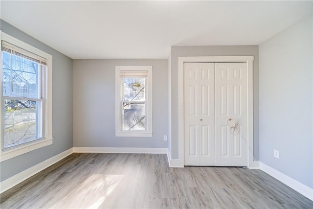 unfurnished bedroom featuring a closet and light hardwood / wood-style flooring