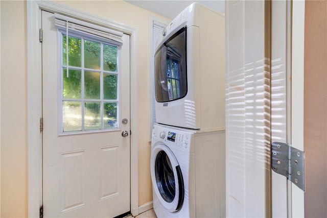 clothes washing area with stacked washer / dryer