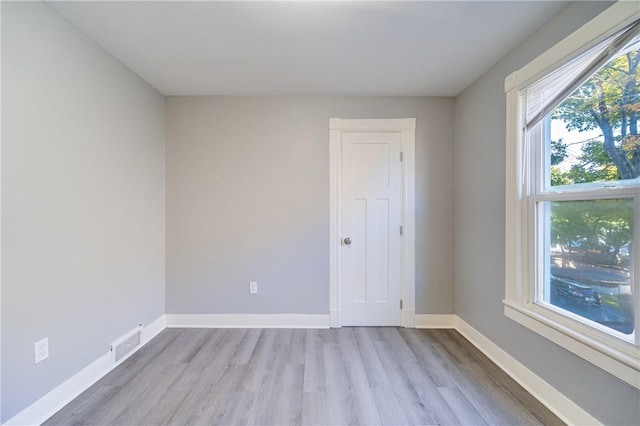 unfurnished room with light wood-type flooring