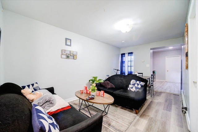 living room featuring light wood-type flooring and a baseboard radiator