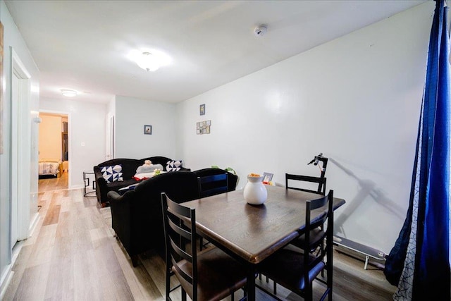 dining space with hardwood / wood-style floors