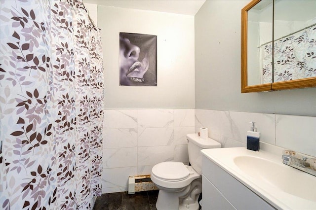 bathroom featuring walk in shower, vanity, tile walls, and toilet