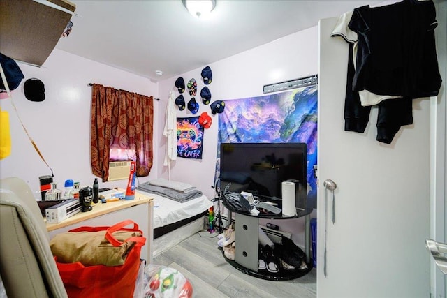 bedroom featuring light hardwood / wood-style floors and cooling unit