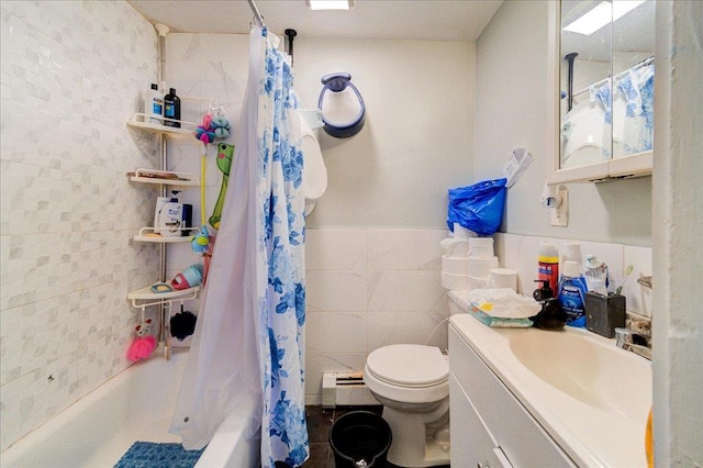 full bathroom featuring vanity, shower / tub combo with curtain, a baseboard radiator, tile walls, and toilet