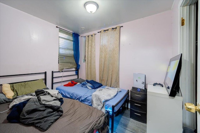 bedroom with wood-type flooring