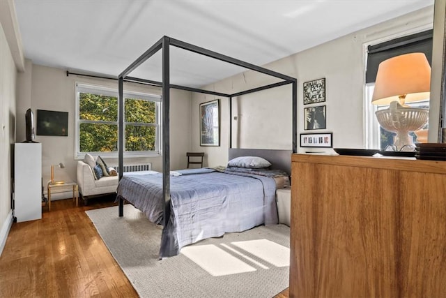 bedroom featuring wood-type flooring and radiator