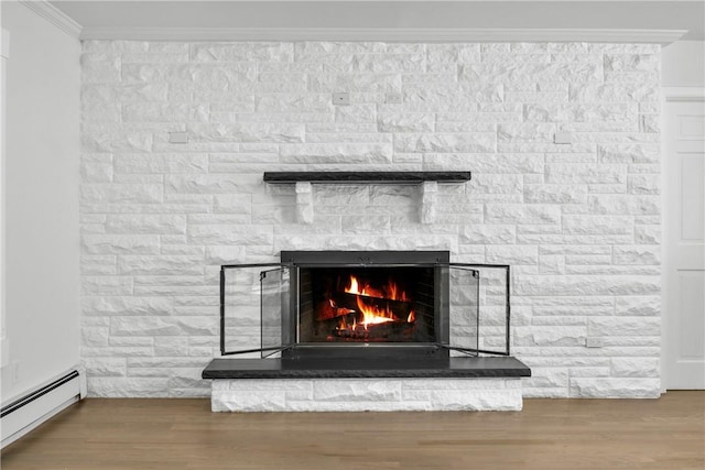 room details featuring a stone fireplace, crown molding, a baseboard radiator, and hardwood / wood-style flooring