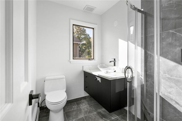 bathroom with vanity, toilet, and a shower with shower door