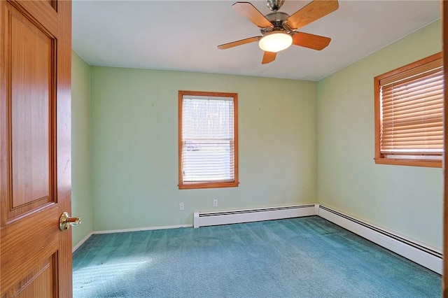 carpeted empty room with baseboard heating and ceiling fan
