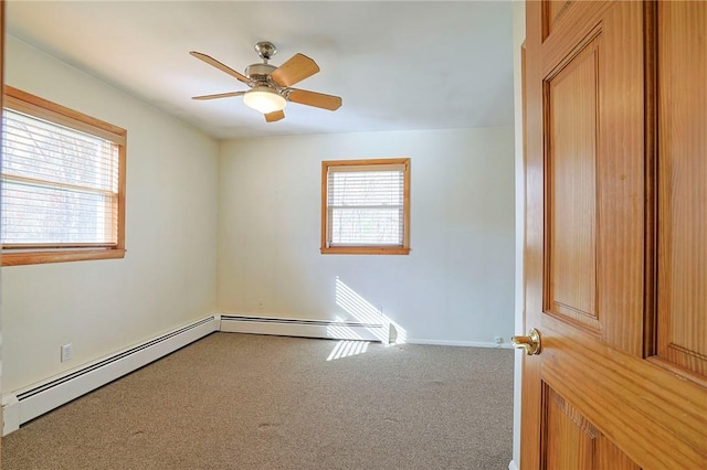 carpeted empty room with baseboard heating, plenty of natural light, and ceiling fan