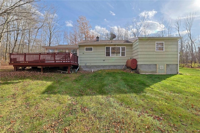 back of house featuring a yard and a wooden deck