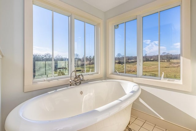 bathroom with a bath and tile patterned floors