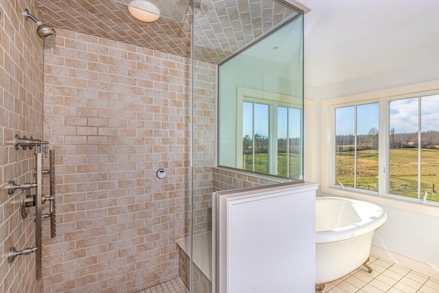 bathroom with shower with separate bathtub and tile patterned floors