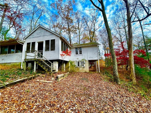 back of property with a sunroom