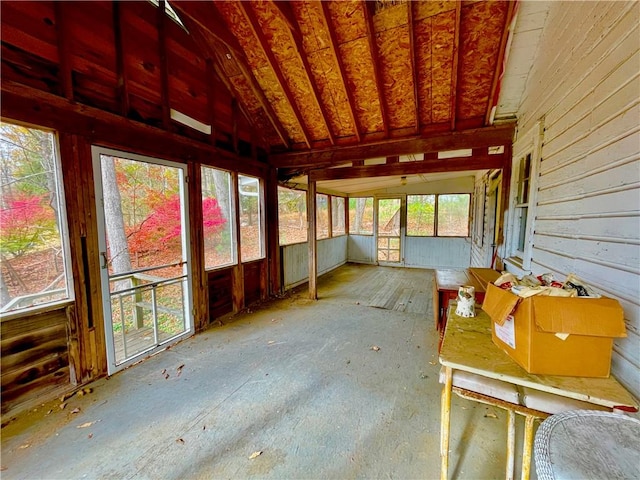 unfurnished sunroom featuring lofted ceiling