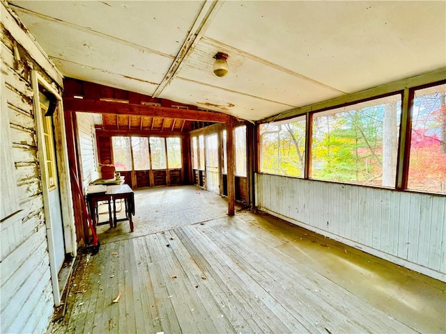 unfurnished sunroom featuring vaulted ceiling