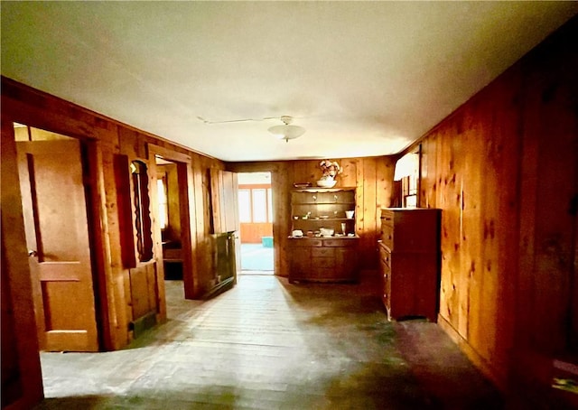 hallway with wood walls