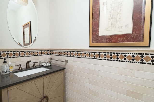 bathroom with vanity and tile walls