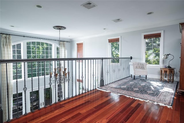 sitting room featuring a healthy amount of sunlight, crown molding, and wood-type flooring