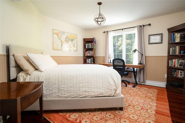 bedroom featuring wooden walls and hardwood / wood-style floors