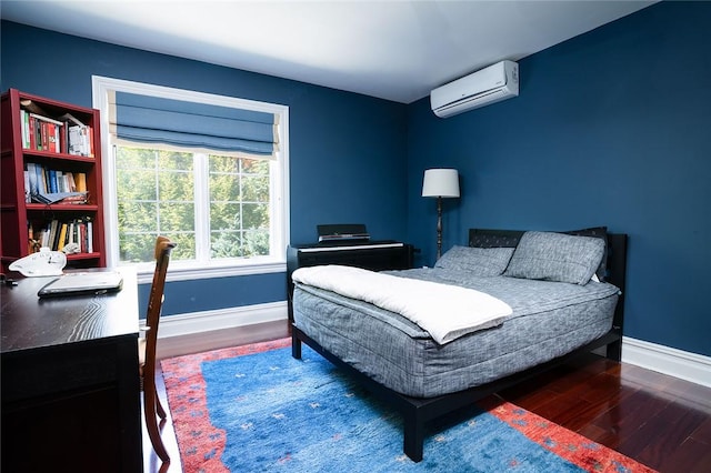 bedroom with a wall mounted air conditioner and dark hardwood / wood-style flooring