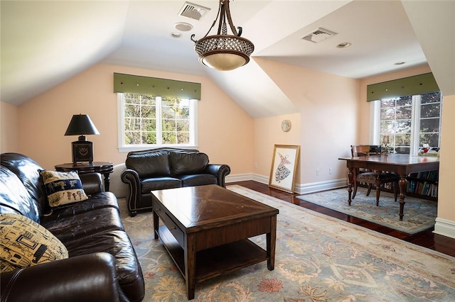 living room with hardwood / wood-style flooring and vaulted ceiling