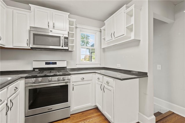 kitchen featuring white cabinetry, light hardwood / wood-style flooring, and appliances with stainless steel finishes