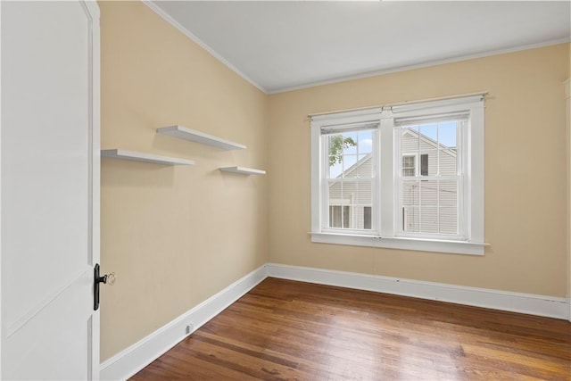 empty room featuring crown molding and hardwood / wood-style floors