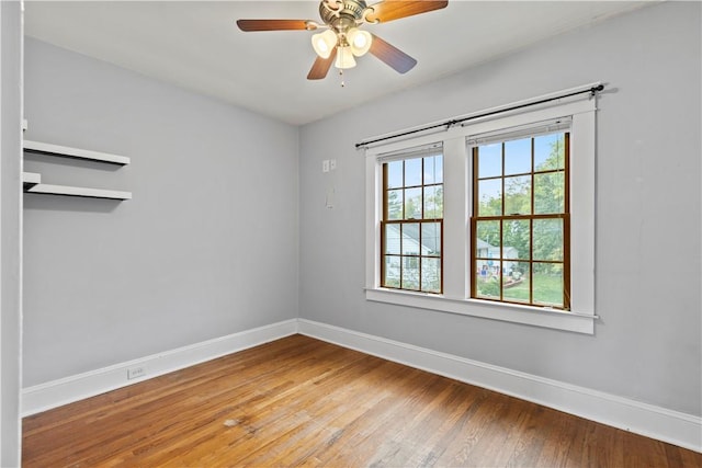 unfurnished room with hardwood / wood-style flooring and ceiling fan