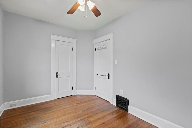 unfurnished room with hardwood / wood-style flooring and ceiling fan