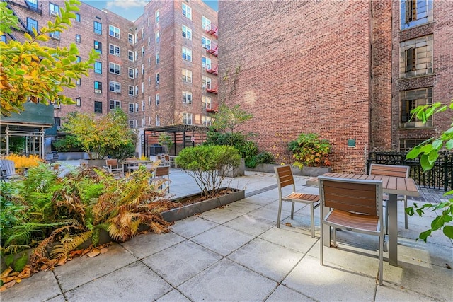 view of community featuring a pergola and a patio