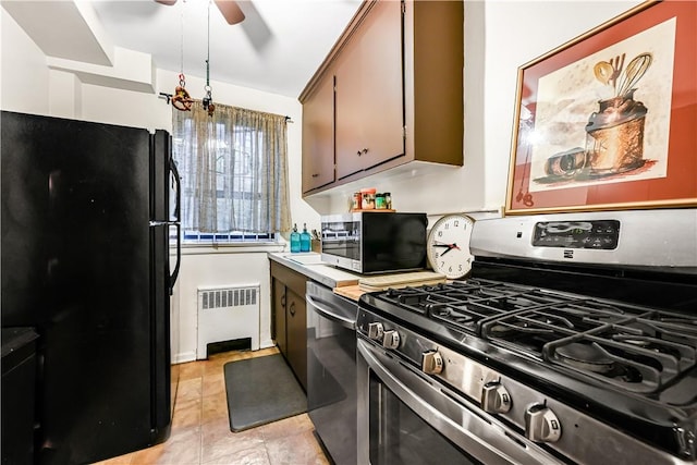 kitchen featuring ceiling fan, radiator heating unit, and appliances with stainless steel finishes