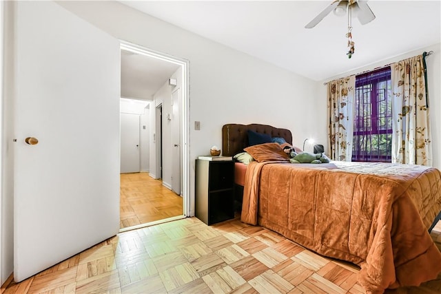 bedroom with ceiling fan and light parquet floors