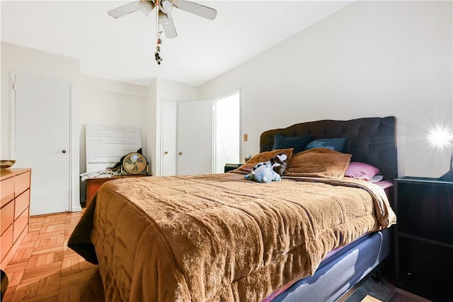 bedroom with ceiling fan and light parquet flooring