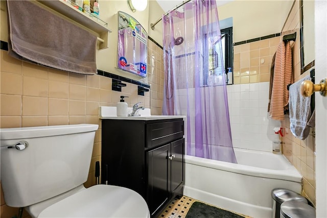 full bathroom featuring toilet, vanity, shower / tub combo with curtain, and tile walls