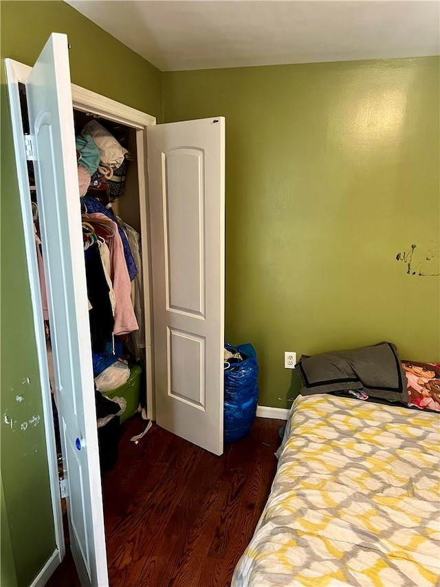 bedroom featuring dark hardwood / wood-style floors and a closet