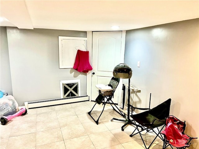 misc room featuring light tile patterned flooring and a baseboard heating unit