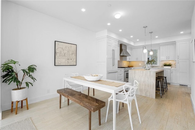 dining area featuring light wood-type flooring