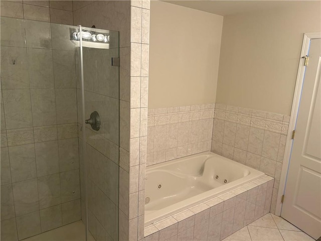 bathroom featuring plus walk in shower and tile patterned flooring