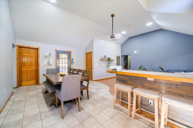 tiled dining room with vaulted ceiling