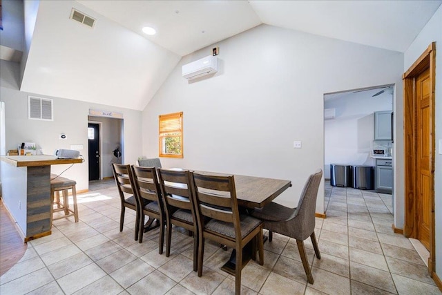 tiled dining space with high vaulted ceiling and a wall mounted AC