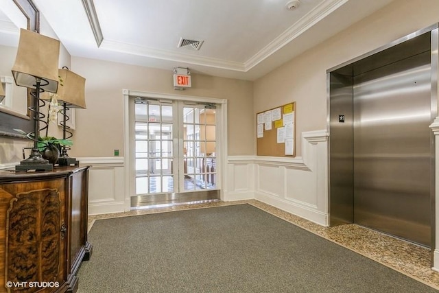 interior space with elevator and a tray ceiling